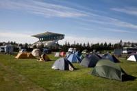 The tents with the reception and entrance building in the background.